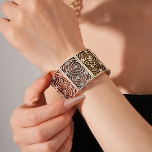 Detailed close-up of a vintage hollowed square bracelet with rhinestones on model wrist