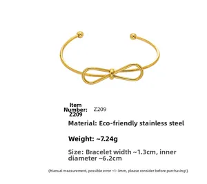Detailed view of gold bow knot open bangle with specifications and measurements