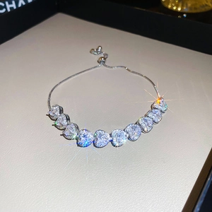 Detail view of silver adjustable bracelet featuring ten sparkling heart-shaped zircons