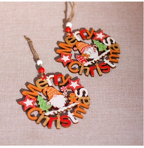 Close-up of wooden hollow Christmas ornaments with Merry Christmas text on beige fabric