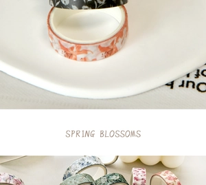 Macro detail of floral washi tape rolls featuring colorful spring blossom patterns