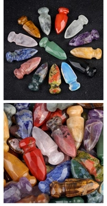 Detailed arrangement of arrowhead carved natural amethyst and tiger eye crystal stones