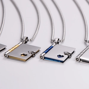 Stainless steel heart-shaped book locket necklaces in gold, blue, and silver finishes