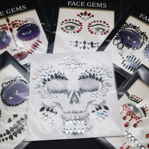 Close-up of assorted Halloween spider and skull face gems in various gothic colors