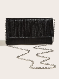 Detail view of black evening envelope clutch with vertical pleated texture and silver chain