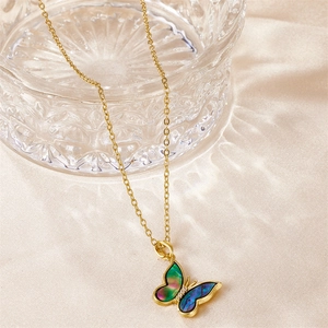 Detailed view of a gold butterfly necklace featuring vibrant iridescent inlay and zircon