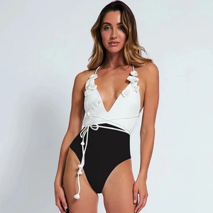 Detail of white 3D floral decoration on V-neck black and white contrast swimsuit