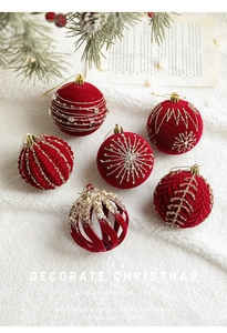 Detail of 8cm burgundy velvet Christmas balls with gold glitter patterns on pine branches