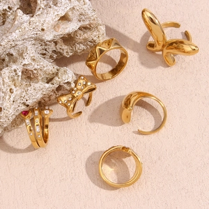 Golden 18K plated stainless steel ring set with butterfly and snake designs on pink background