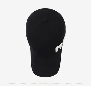 Top down view of black cotton baseball cap with white M letter embroidery on the side