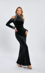 Detailed view of black velvet dress featuring luxury pearl and rhinestone shoulder accents
