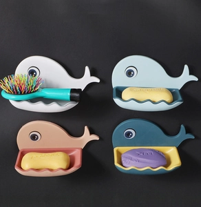 Detail view of colorful whale-shaped wall-mounted soap holders in four assorted colors
