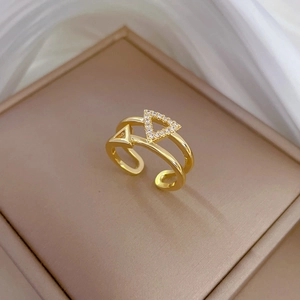 Double layered gold triangle ring with sparkling cubic zirconia on display stand