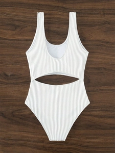 Detailed view of white ribbed fabric texture and waist cutout on a one-piece swimsuit