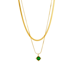 Double-layered gold necklace featuring a flat snake chain and green square gem pendant