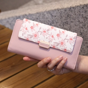 Macro detail of pink floral print PU leather long wallet with gold metal clasp