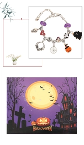 Close-up of Halloween charm bracelet with pumpkin, ghost, and bat pendants