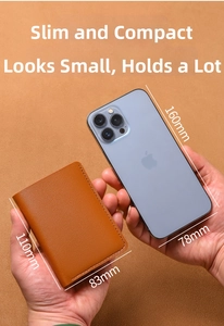 Slim brown leather wallet size comparison 110mm x 83mm shown held in hands