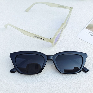 Fashionable black and translucent yellow cat-eye sunglasses with dark grey lenses