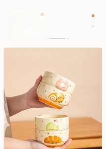 Close-up of thick ceramic bowls with cartoon bread patterns and heat-resistant walls