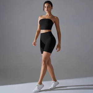 Close-up of black two-piece yoga set with strapless crop top and high waist cycling shorts