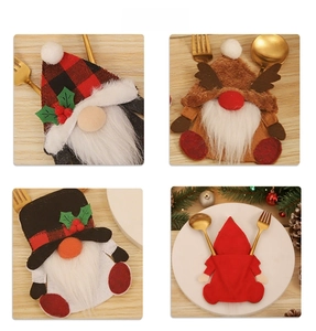 Detail view of gnome Christmas cutlery holders with plaid hats and reindeer antlers