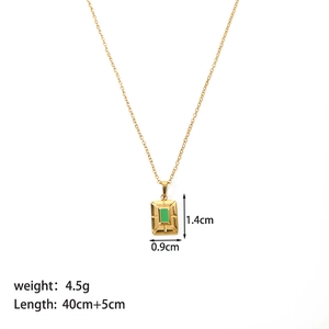 Detail view of gold titanium steel necklace with green rectangular evil eye pendant