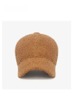 Close-up of brown sherpa fleece baseball cap with high-quality white embroidery detail