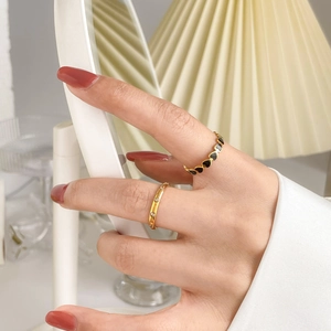 Chic gold stackable ring set featuring black heart enamel and sparkling pave zircon accents