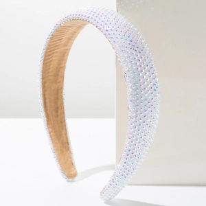 Close-up of wide padded headband with sparkling multicolored rhinestones on white base