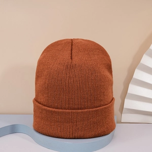 Detailed knit texture of orange LOS ANGELES beanie on a minimalist geometric display stand