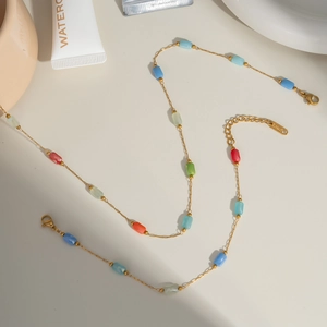 Gold stainless steel chain necklace with colorful crystal beads in an S-shape layout