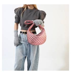 Metallic hot pink quilted hobo bag styled with a grey knit top and matching gloves