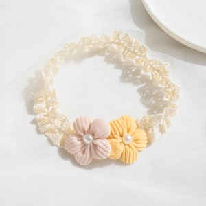 Lace baby headband with soft pink and yellow fabric flowers and pearl accents