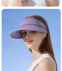 Detail view of purple UPF50+ women sun visor hat with stylish logo and curved brim