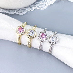 Detail of elegant heart-shaped rings with pink and white cubic zirconia in macro view
