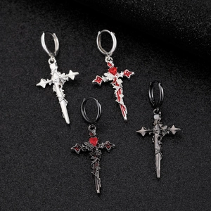 Detailed view of Gothic cross hoop earrings with thorn vine patterns and red heart gems