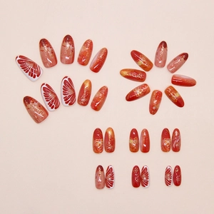 Flat lay detail of almond press-on nails with red marble, floral and stripe patterns