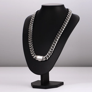 Polished silver stainless steel Cuban link chain necklace displayed on a black neck bust