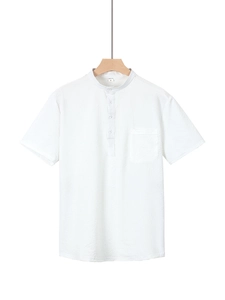 Detailed macro view of white textured seersucker fabric on a men's short sleeve Henley shirt