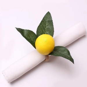 Detailed close-up of artificial lemon napkin ring with green leaves and jute rope