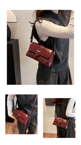 Detail of vintage burgundy shoulder bag with glossy texture and elegant metal buckle
