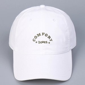 Detail of white cotton baseball cap showing Comfort Zones embroidery and six-panel design