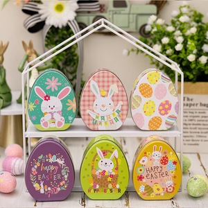 Set of six colorful Easter egg tin boxes with bunny patterns on a white display rack