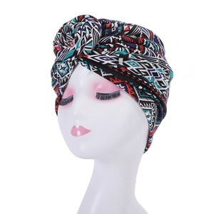 Front view of turban hat with geometric ethnic pattern on white mannequin head