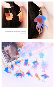 Detail of DIY animal silicone molds and glitter resin earrings with ocean theme shapes