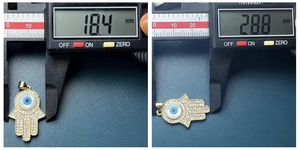 Detailed measurement of gold Hamsa Hand pendant with evil eye showing 18.4mm by 28.8mm