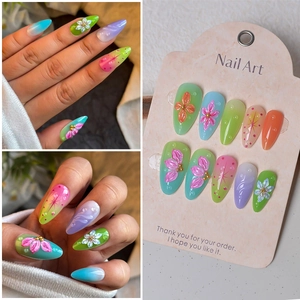 Detail of 3D embossed floral nail charms with gradient colors and water drop accents
