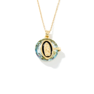 Religious necklace with gold chain and green crystal Virgin Mary pendant on white background