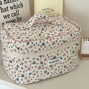 Floral quilted corduroy makeup bag with top handle and vintage cottagecore aesthetic
